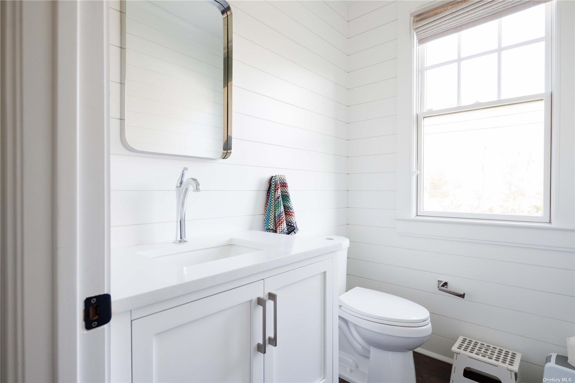 2415 Cox Neck Road Mattituck, NY 11952 - Photo 9 of 10 a bathroom with a sink toilet and mirror