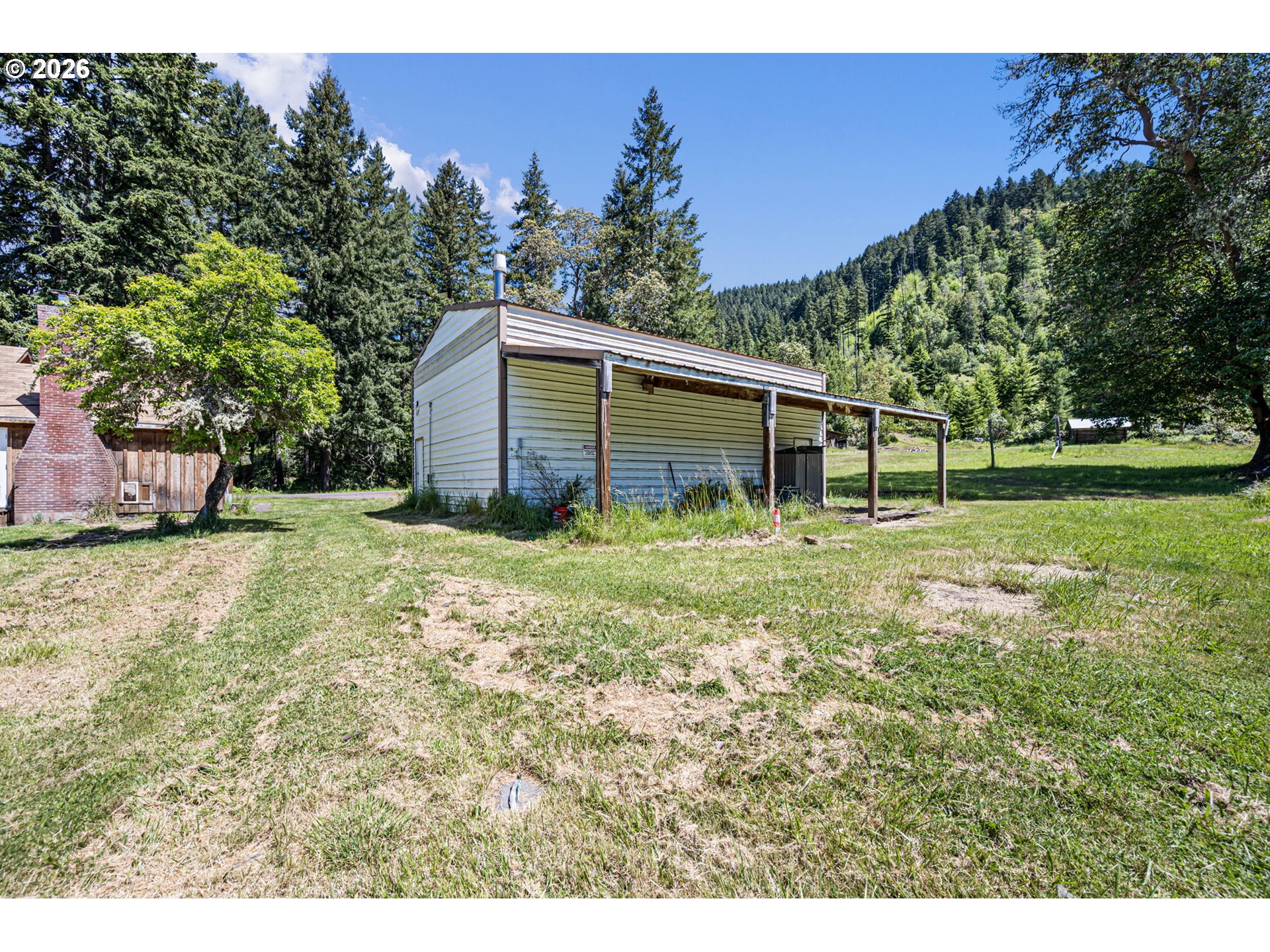 77521 Brock Road Oakridge, OR 97463 - Photo 44 of 48 a backyard of a house with lots of green space