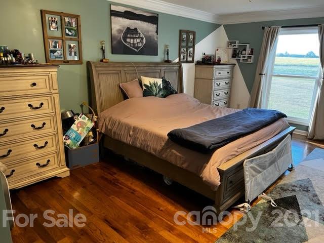 628 Champion Ferry Road Gaffney, SC 29341 - Photo 12 of 26 a bedroom with a bed and wooden floor
