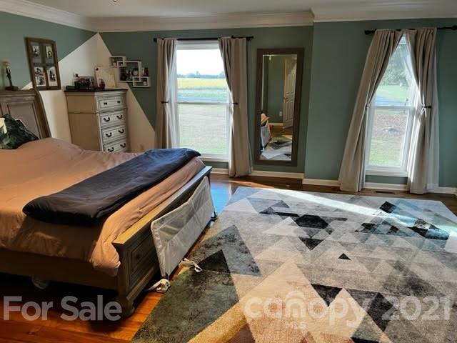 628 Champion Ferry Road Gaffney, SC 29341 - Photo 13 of 26 a bedroom with a bed and wooden floor