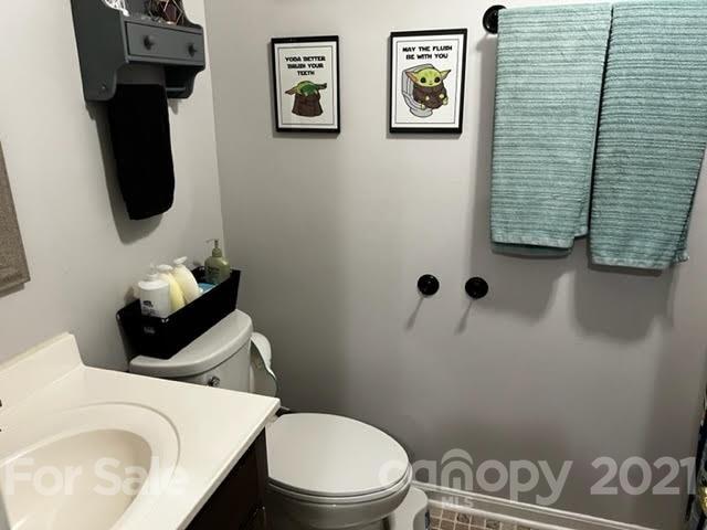 628 Champion Ferry Road Gaffney, SC 29341 - Photo 19 of 26 a white toilet sitting next to a bathroom sink