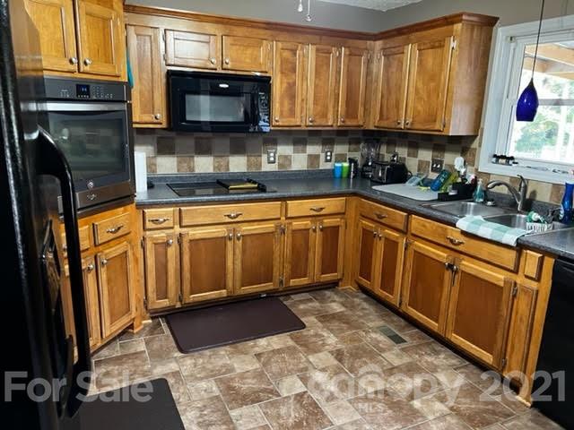 628 Champion Ferry Road Gaffney, SC 29341 - Photo 22 of 26 a kitchen with stainless steel appliances granite countertop a stove a sink and a microwave