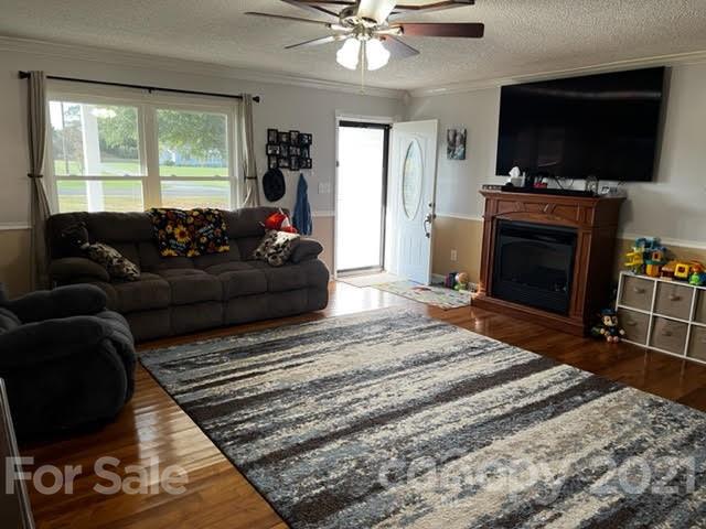 628 Champion Ferry Road Gaffney, SC 29341 - Photo 4 of 26 a living room with furniture a flat screen tv and a fireplace