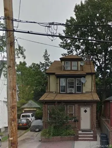 a front view of a house with plants