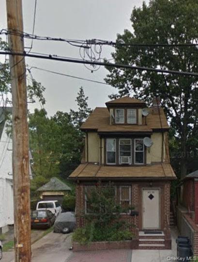 a front view of a house with plants