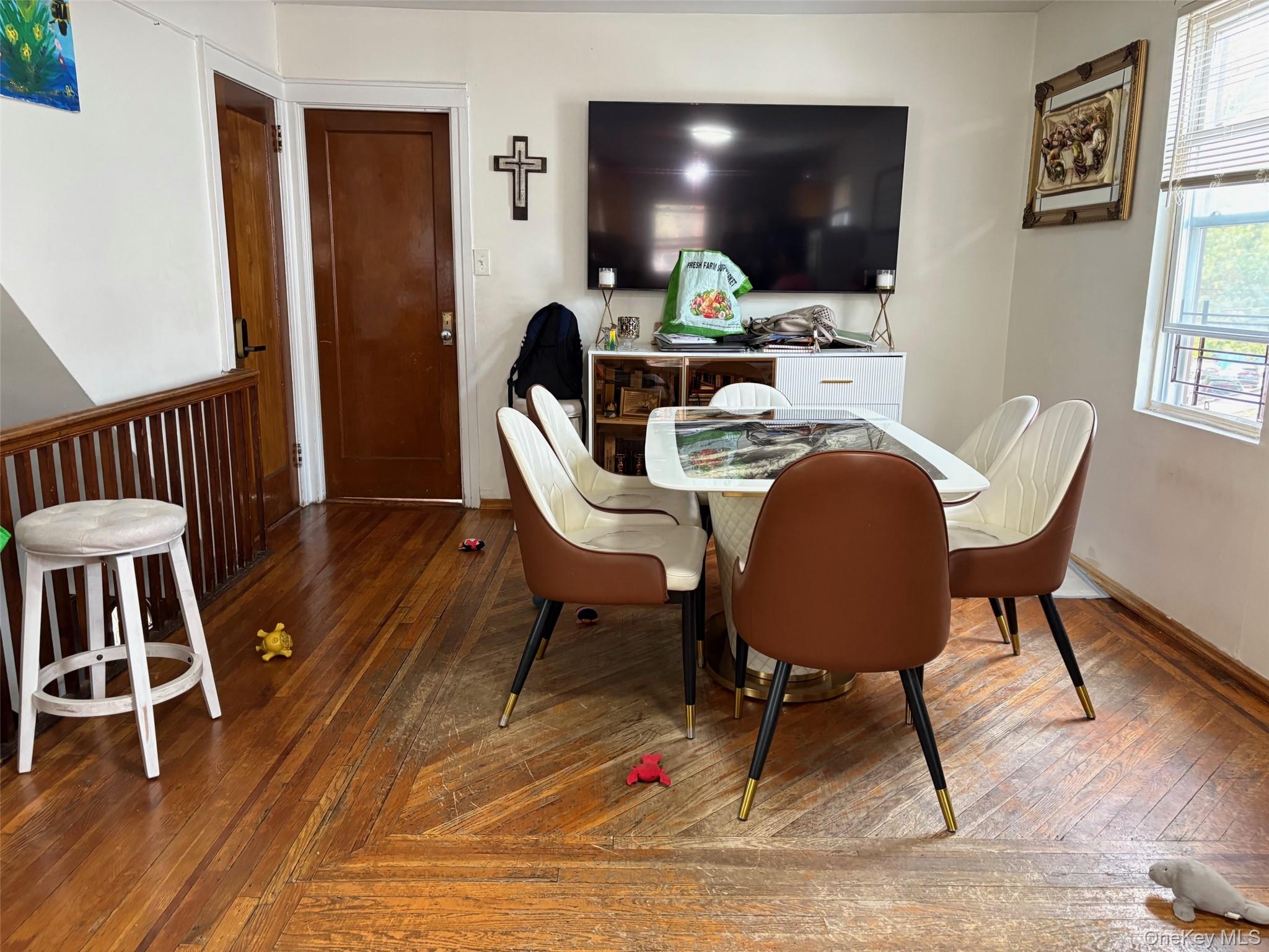 140-99 Burden Crescent, Unit 2 Queens, NY 11435 - Photo 3 of 8 a view of a workspace with furniture window and wooden floor