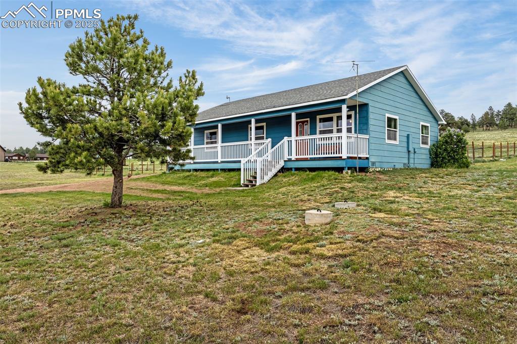 406 High Pasture Road Florissant, CO 80816 - Photo 3 of 28 a front view of a house with garden