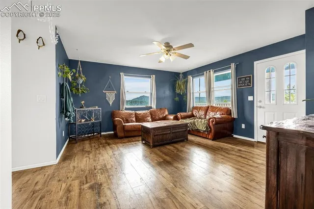 a living room with furniture and a large window