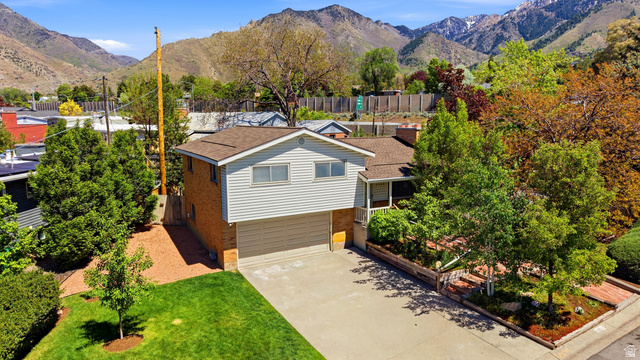 4245 3320 East Holladay, UT 84124 - Photo 5 of 51 Split-level residence featuring a brick and siding exterior with a two-car garage
