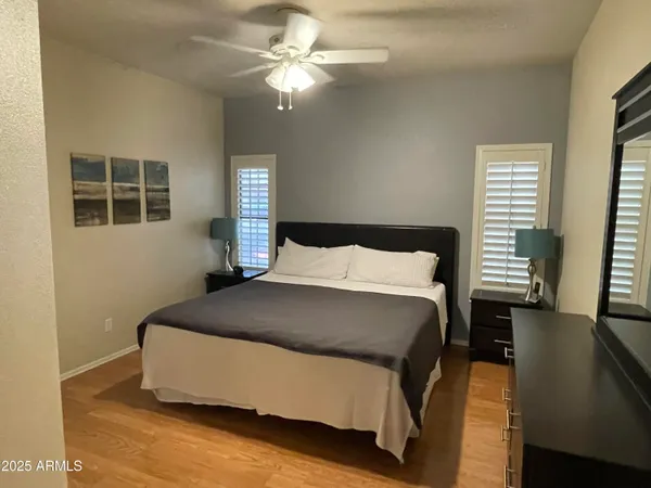 a bedroom with a bed and wooden floor