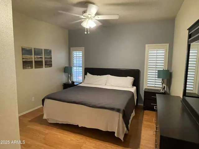a bedroom with a bed and wooden floor