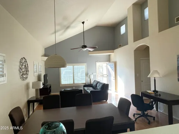 a living room with furniture a window and a chandelier