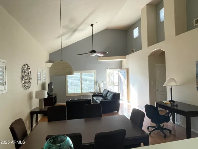 a living room with furniture a window and a chandelier