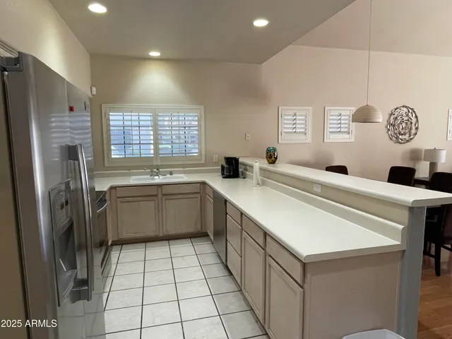 a kitchen with a sink a stove top oven and refrigerator