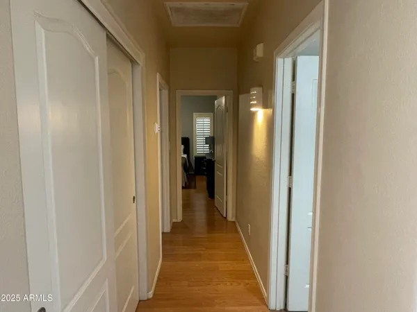 a view of a hallway with a white walls and a door