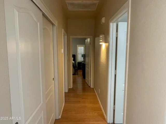 a view of a hallway with a white walls and a door