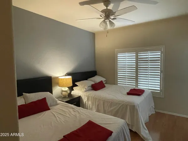 a bedroom with two beds and a chandelier