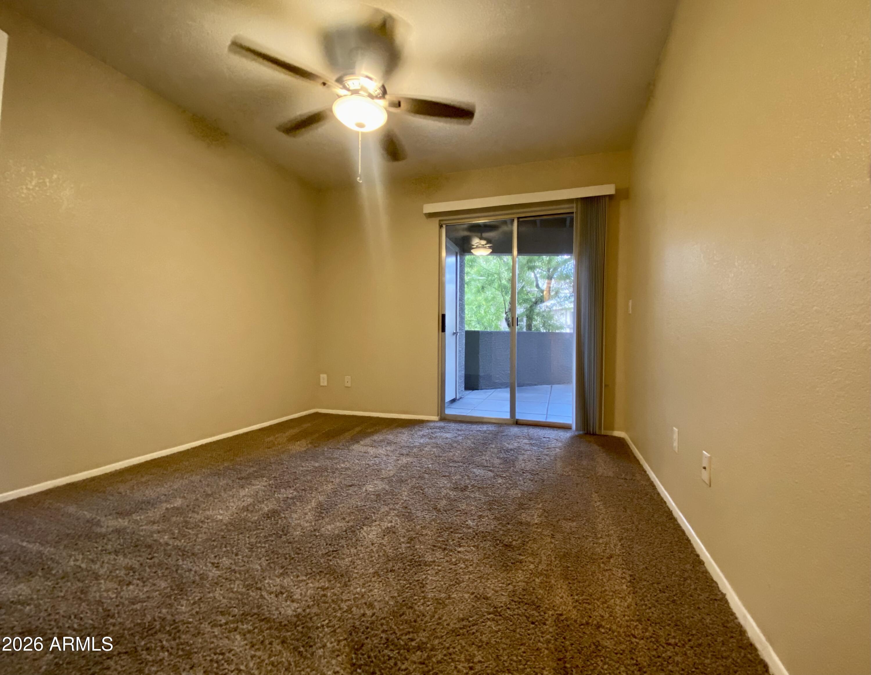 1720 East Thunderbird Road, Unit 1100 Phoenix, AZ 85022 - Photo 13 of 34 a view of an empty room with a chandelier fan