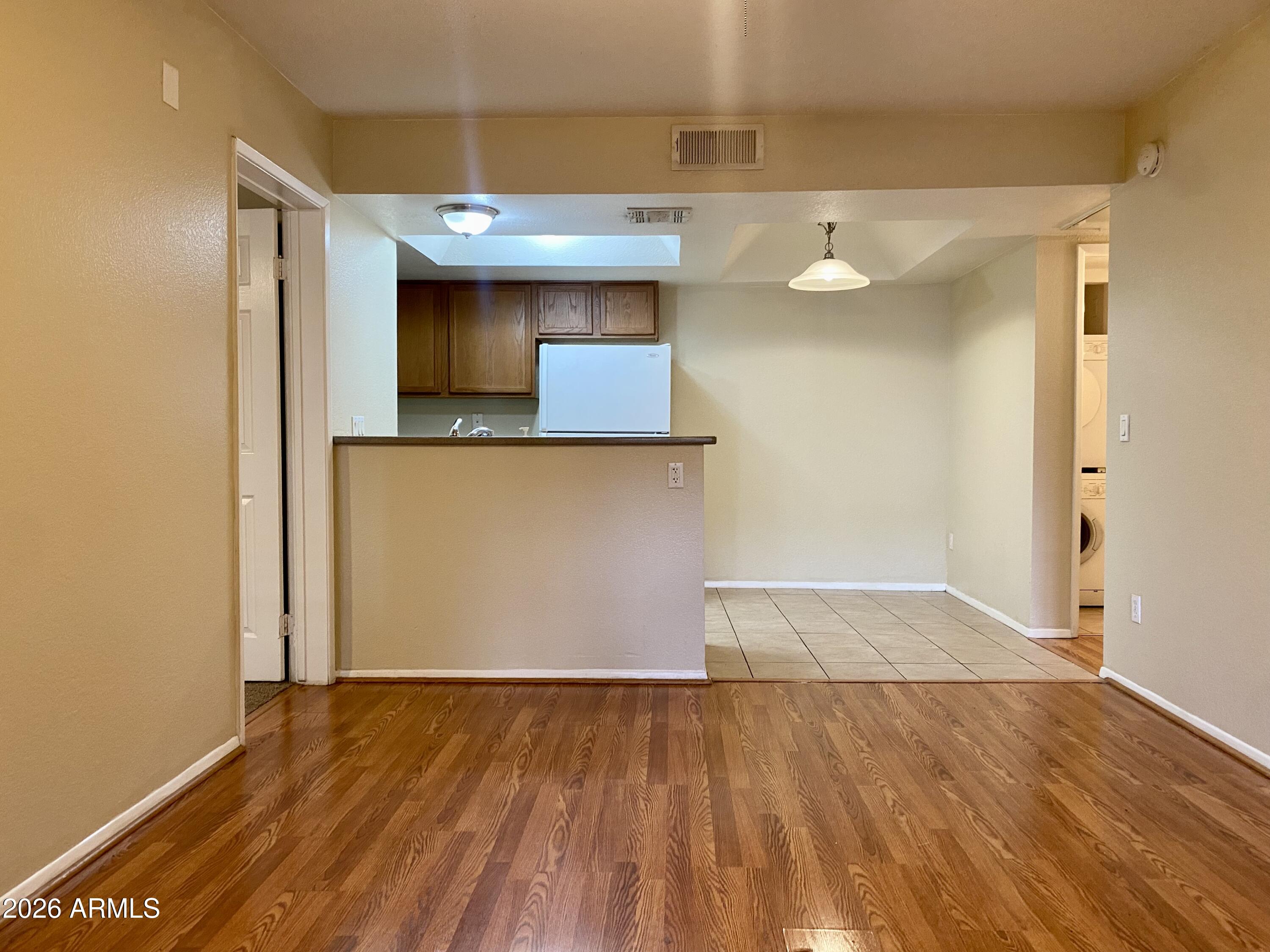 1720 East Thunderbird Road, Unit 1100 Phoenix, AZ 85022 - Photo 2 of 34 a view of a room with wooden floor and cabinet