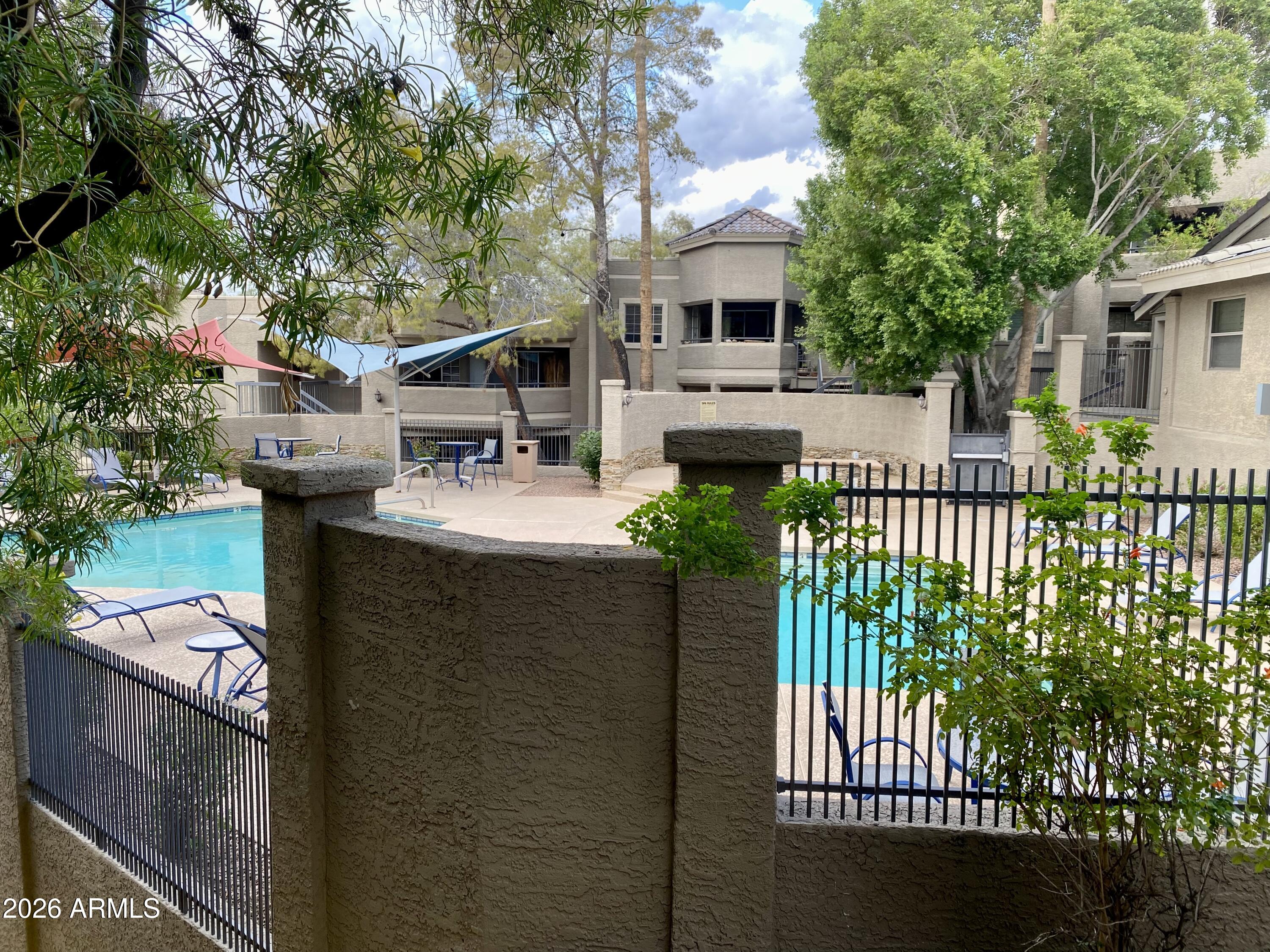 1720 East Thunderbird Road, Unit 1100 Phoenix, AZ 85022 - Photo 21 of 34 a balcony with couple of trees in front of it