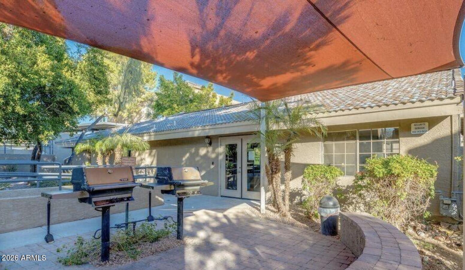 1720 East Thunderbird Road, Unit 1100 Phoenix, AZ 85022 - Photo 24 of 34 a front view of a house with a garden and porch