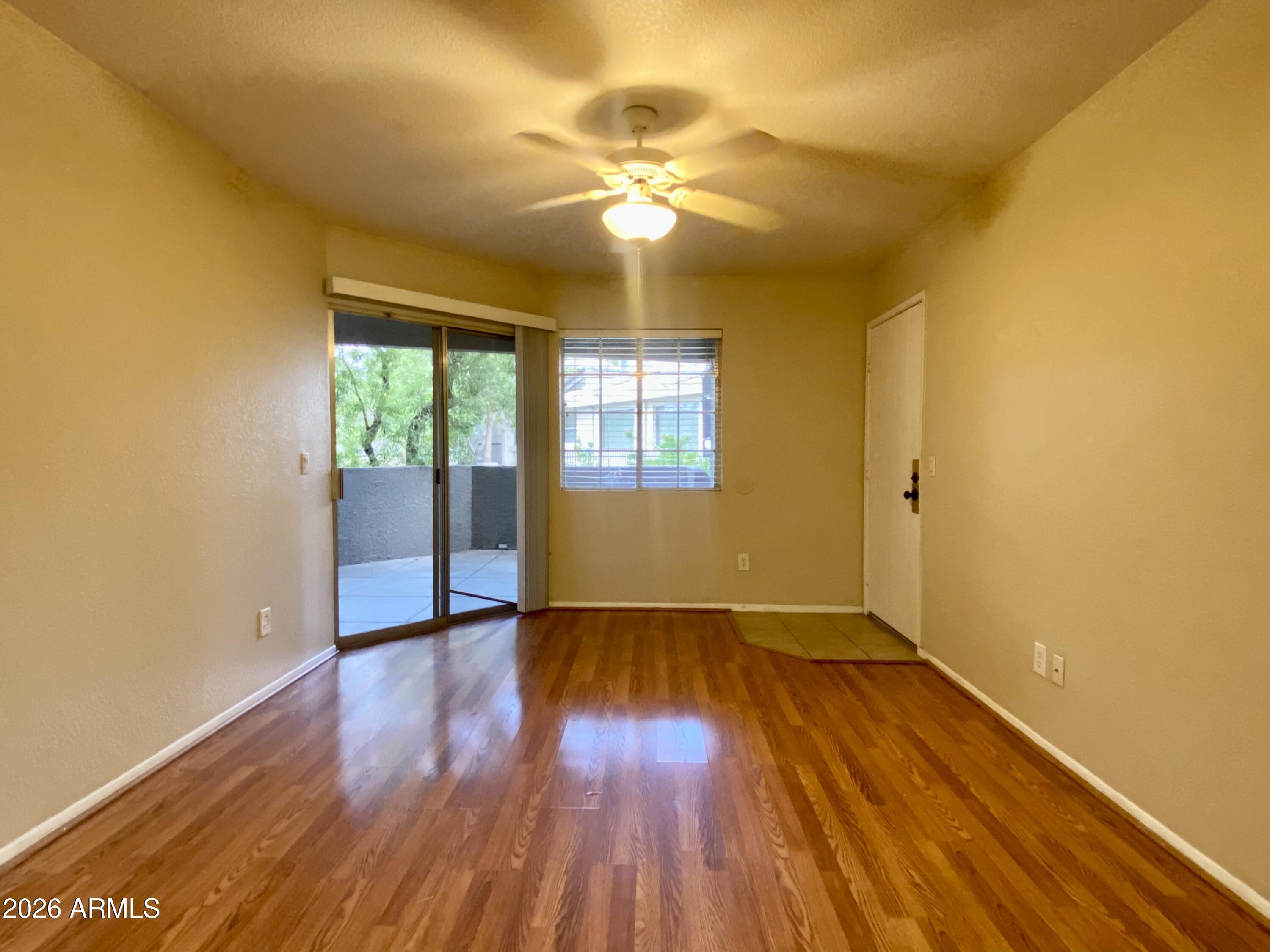 1720 East Thunderbird Road, Unit 1100 Phoenix, AZ 85022 - Photo 3 of 34 a view of an empty room with wooden floor and a window