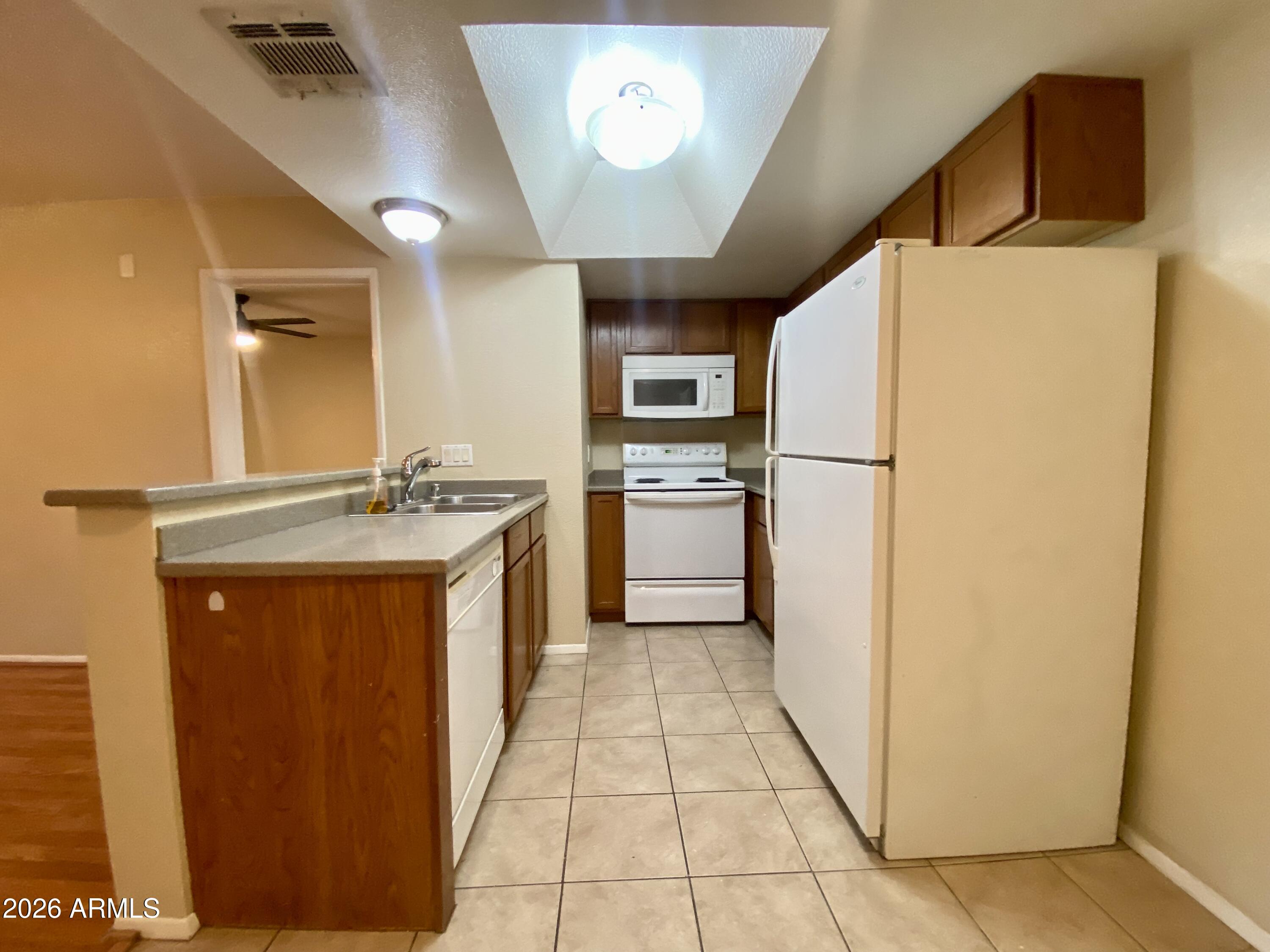 1720 East Thunderbird Road, Unit 1100 Phoenix, AZ 85022 - Photo 4 of 34 a kitchen with a refrigerator sink and stove