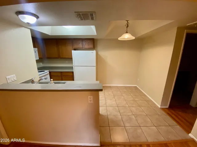 a kitchen with a sink a toilet and a mirror