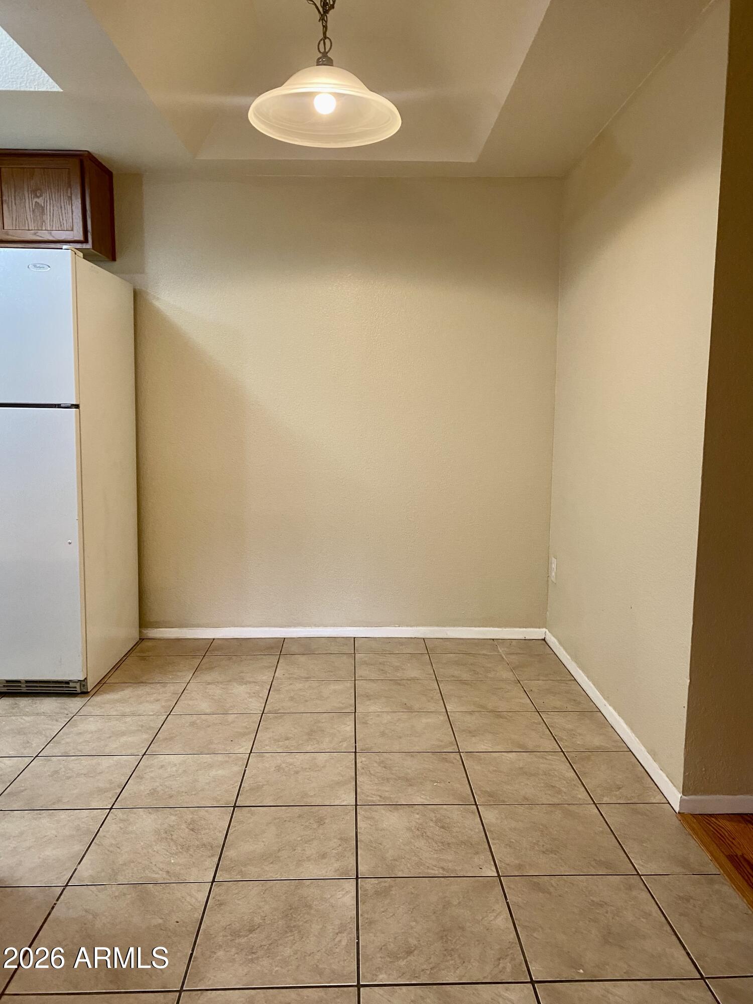 1720 East Thunderbird Road, Unit 1100 Phoenix, AZ 85022 - Photo 6 of 34 a view of an empty room and a refrigerator