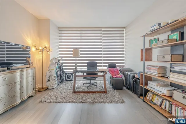 a living room with furniture and a kitchen