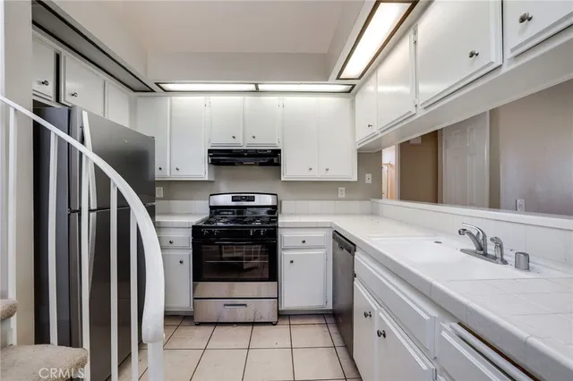 a view of a livingroom with wooden floor and white walls