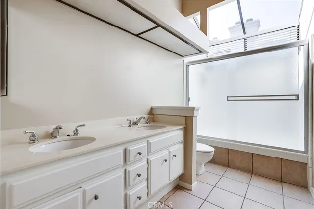 a view of a yard with plants and a bench