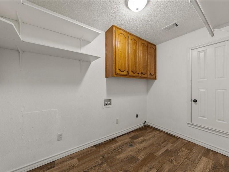 1072 Chapman Road Crawford, TX 76638 - Photo 12 of 39 a view of a room with wooden floor and cabinet
