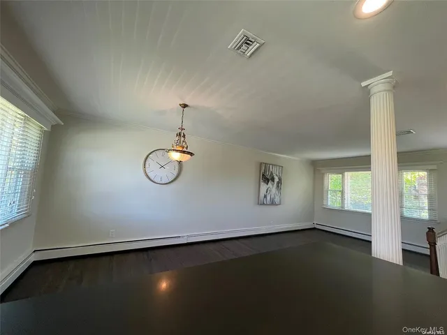 an empty room with windows and closet