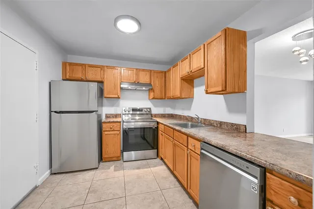 a kitchen with stainless steel appliances granite countertop a refrigerator sink and cabinets