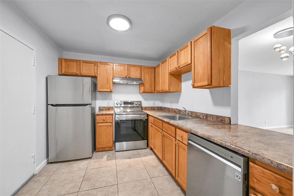 a kitchen with stainless steel appliances granite countertop a refrigerator sink and cabinets