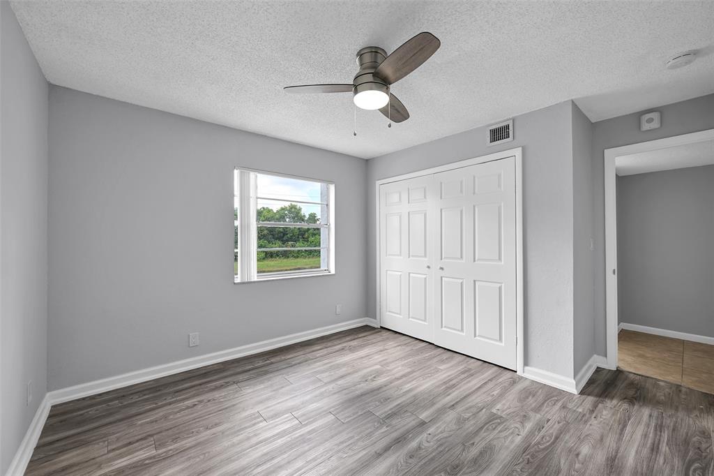7541 Northwest 16th Street, Unit 1211 Plantation, FL 33313 - Photo 15 of 23 a view of an empty room with wooden floor and a window