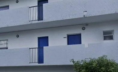 a view of a tall building next to a road