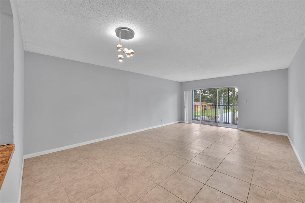 7541 Northwest 16th Street, Unit 1211 Plantation, FL 33313 - Photo 2 of 23 a view of an empty room with a window