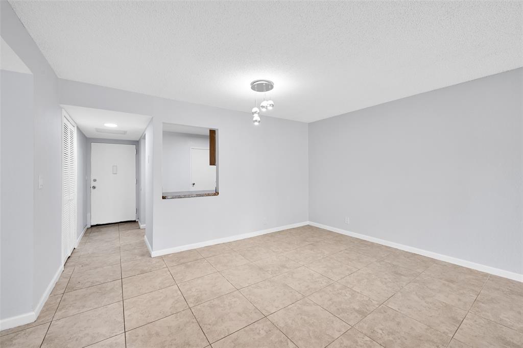 7541 Northwest 16th Street, Unit 1211 Plantation, FL 33313 - Photo 3 of 23 an empty room with a bathroom