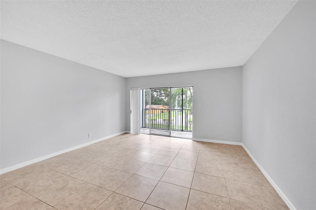 7541 Northwest 16th Street, Unit 1211 Plantation, FL 33313 - Photo 4 of 23 a view of an empty room with a window