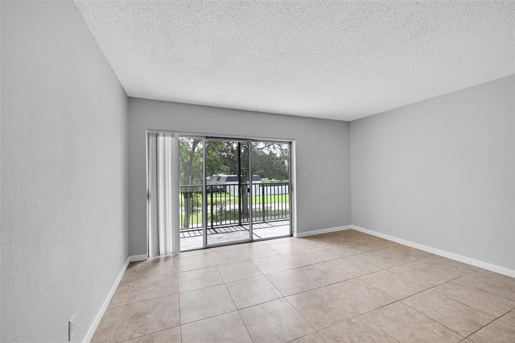 7541 Northwest 16th Street, Unit 1211 Plantation, FL 33313 - Photo 6 of 23 a view of an empty room with a window