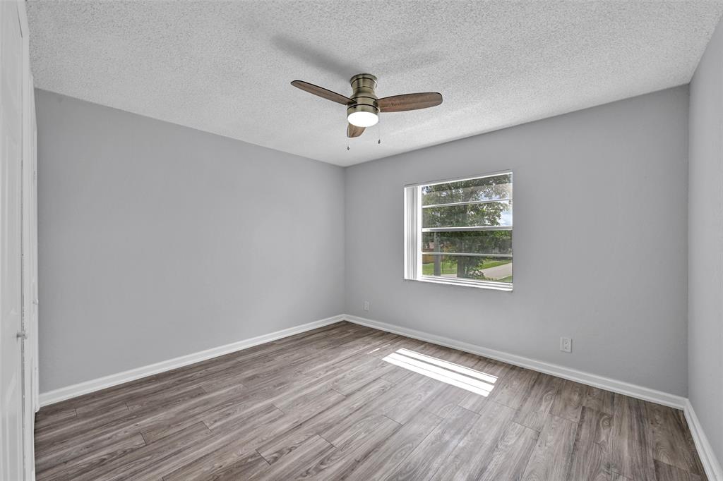 7541 Northwest 16th Street, Unit 1211 Plantation, FL 33313 - Photo 7 of 23 a view of empty room with wooden floor and fan