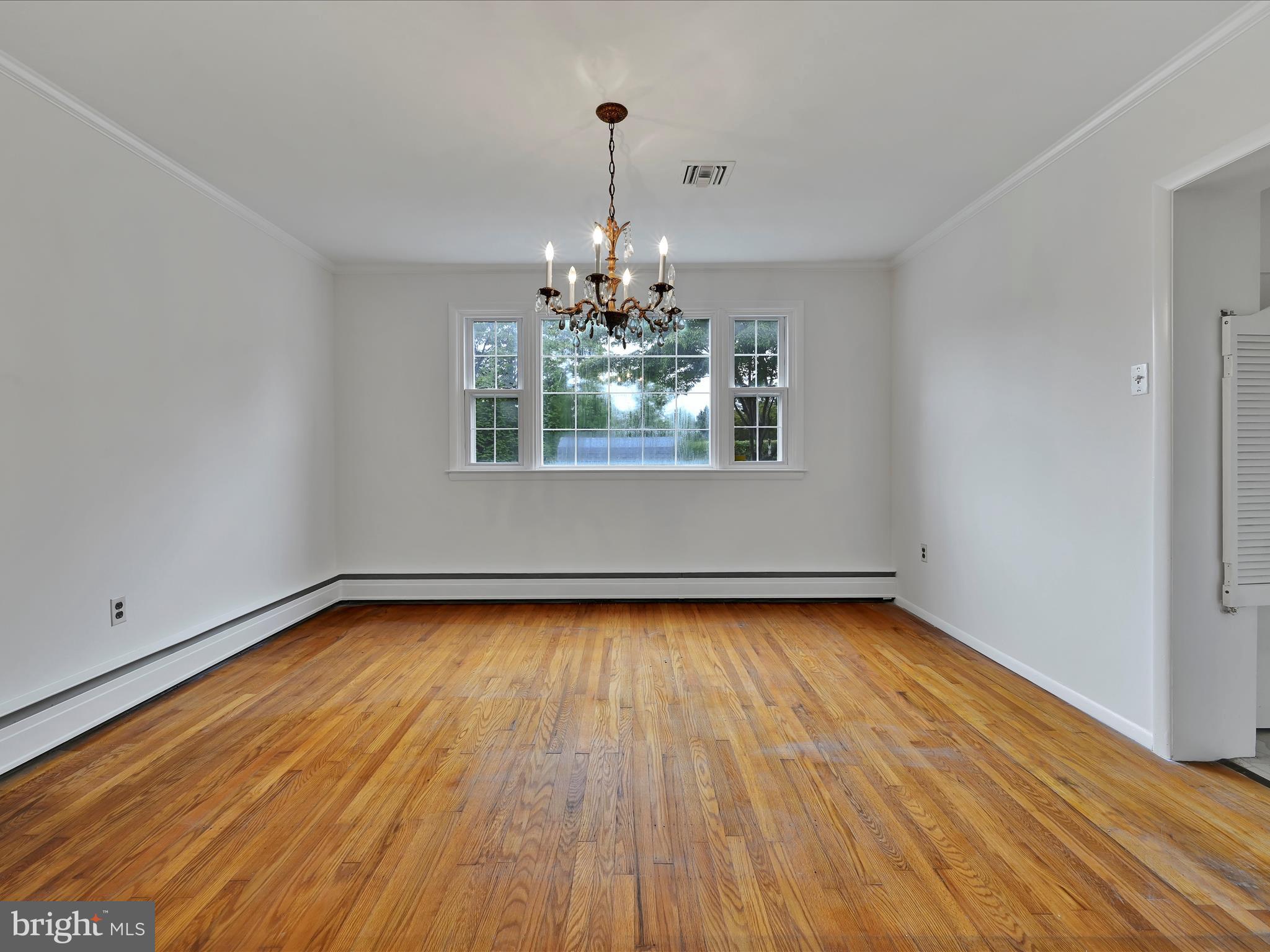 14 Stone Ridge Road Thornton, PA 19373 - Photo 11 of 45 a view of a room with window wooden floor and chandelier