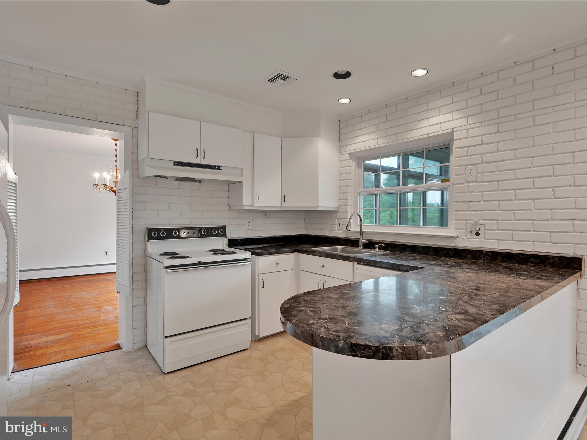 14 Stone Ridge Road Thornton, PA 19373 - Photo 13 of 45 a kitchen with stainless steel appliances granite countertop a sink a stove and a refrigerator
