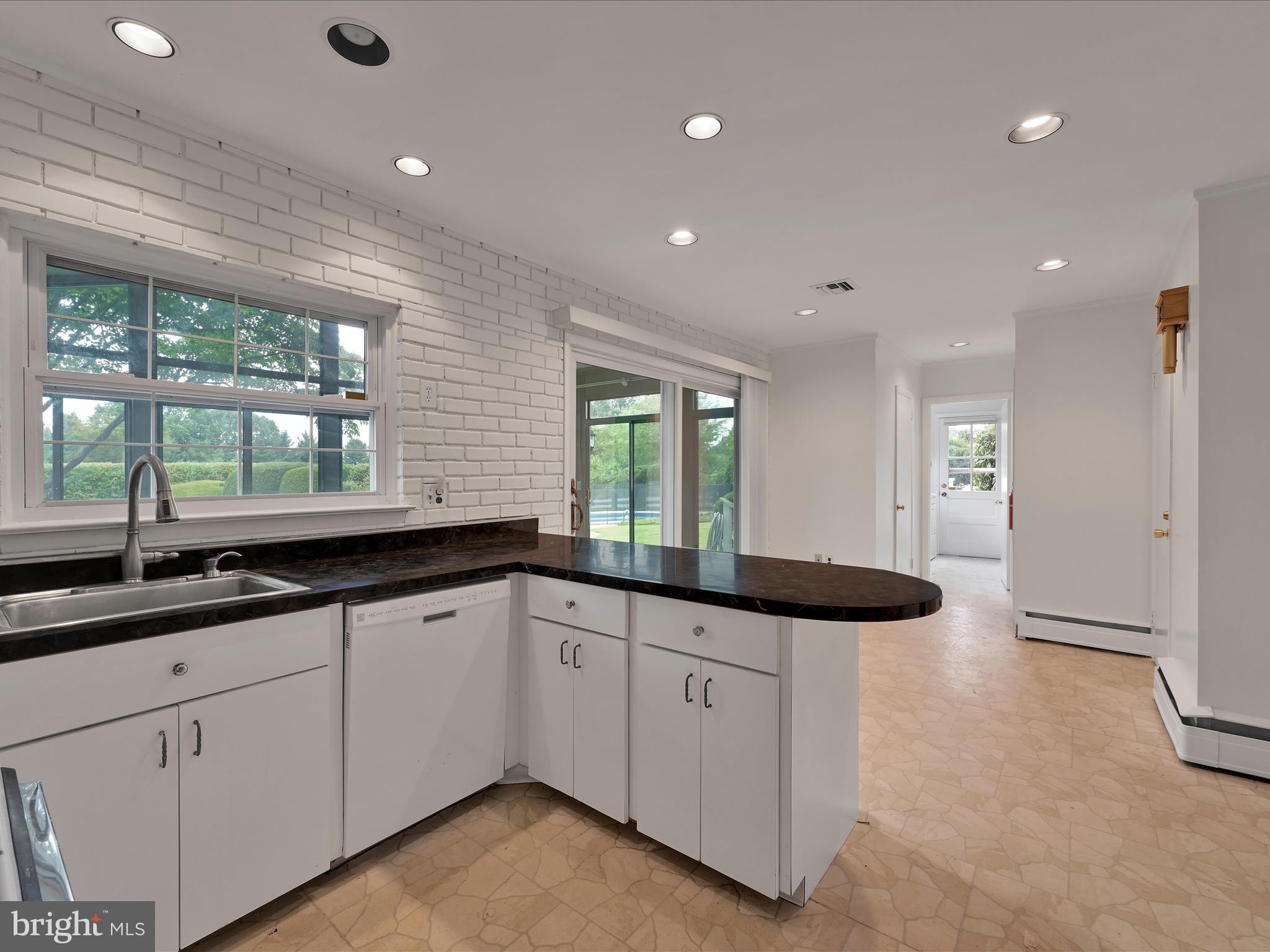 14 Stone Ridge Road Thornton, PA 19373 - Photo 14 of 45 a large kitchen with granite countertop a sink and white cabinets