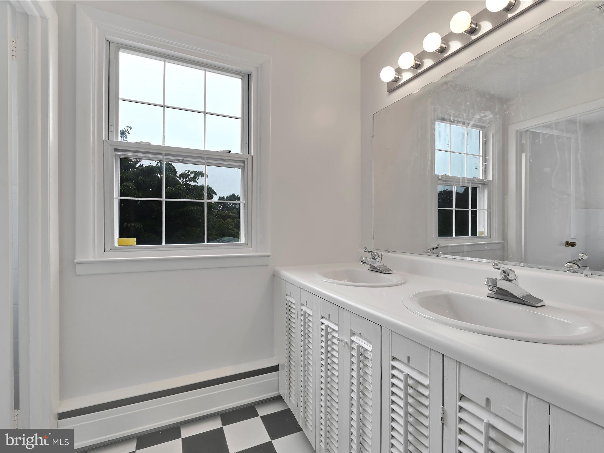 14 Stone Ridge Road Thornton, PA 19373 - Photo 33 of 45 a bathroom with a sink a vanity and a mirror