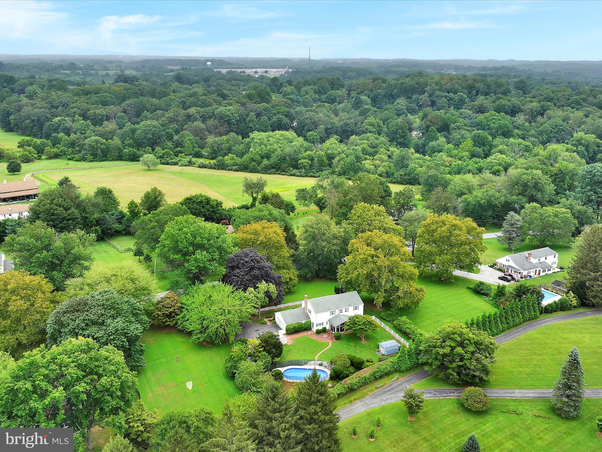 14 Stone Ridge Road Thornton, PA 19373 - Photo 43 of 45 a view of a garden with lawn chairs and large trees