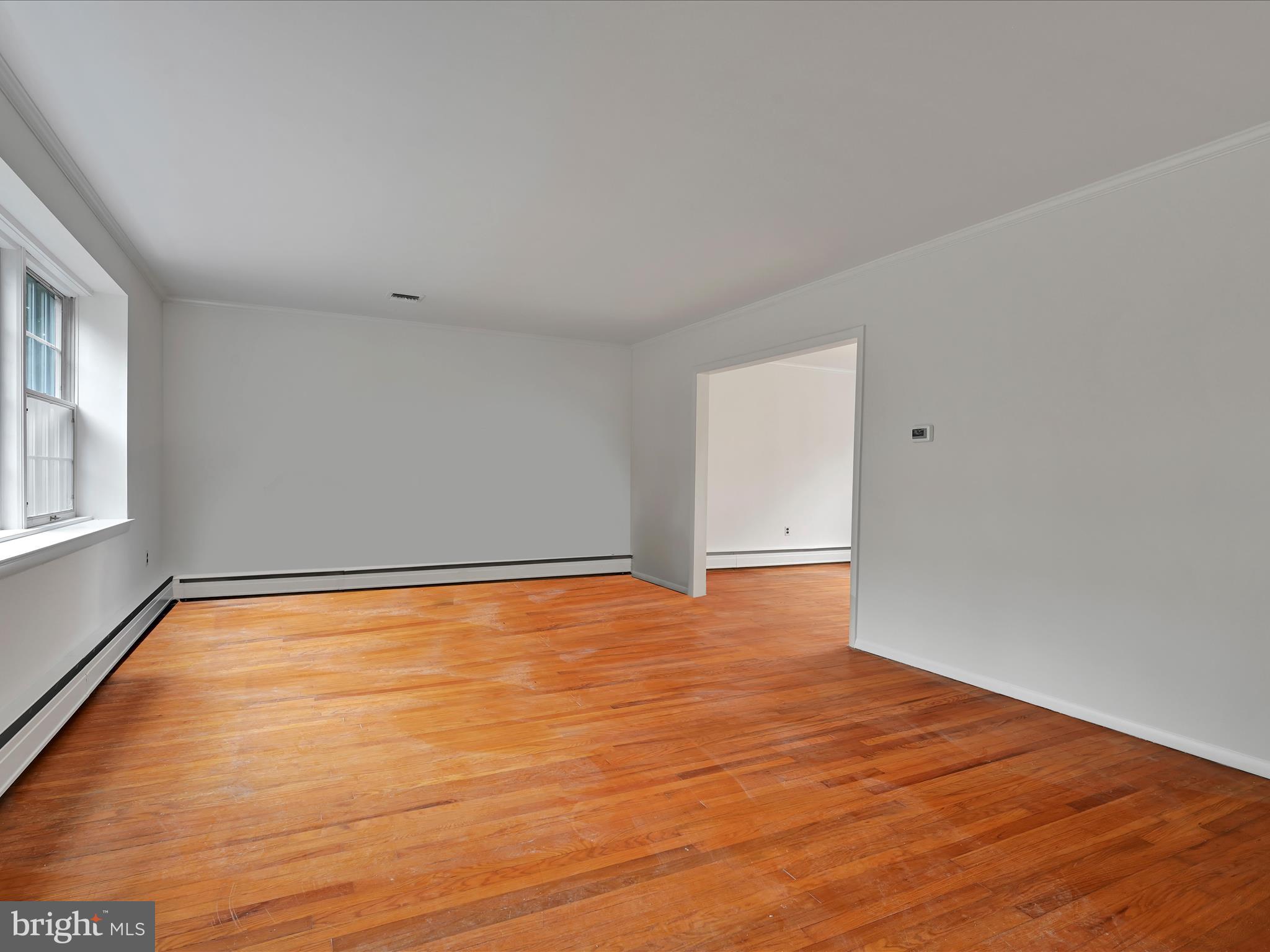 14 Stone Ridge Road Thornton, PA 19373 - Photo 9 of 45 a view of an empty room with wooden floor and a window