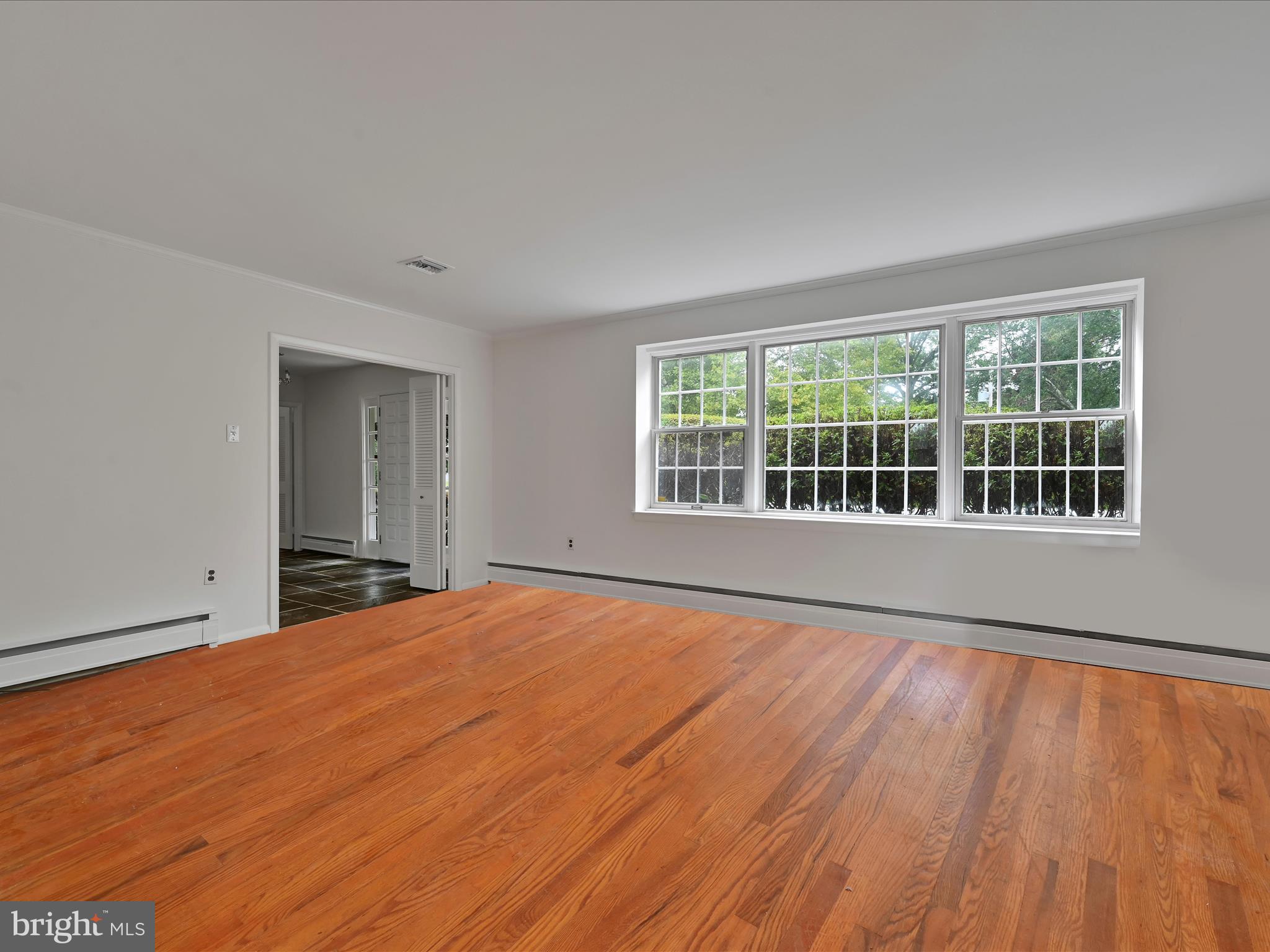 14 Stone Ridge Road Thornton, PA 19373 - Photo 10 of 45 a view of an empty room with wooden floor and a window